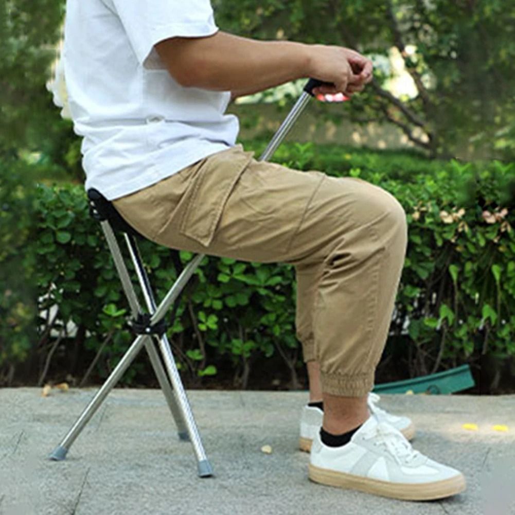 Person using the lightweight folding cane at a concert then sitting comfortably on the builtin sea